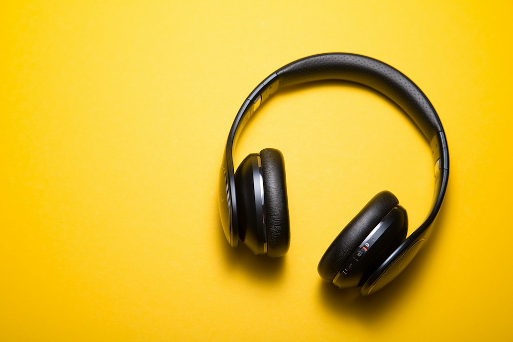 Over-ear headphones on a yellow background